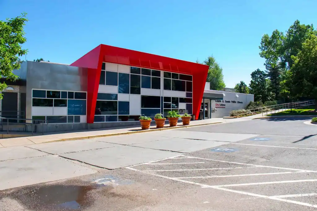 Modern library building with a distinctive red entrance arch.