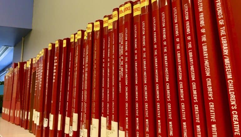 Shelves filled with red books at Littleton Library.